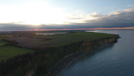 Normandy-coastline-cliffs-during-sunset-aerial-drone-view